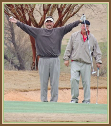 hands raised with golf ball